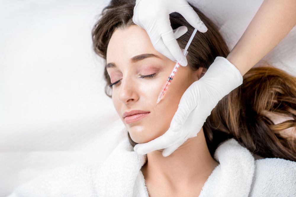 a woman is getting dental treatment.